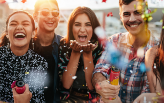 Group-of-friends-celebrating-4th-of-July-with-confetti-cannons